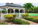 White gazebo with brick pathway and lush landscaping at 9612 Valencia Cv, Bradenton, FL 34210