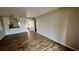 Open living room with light wood-look floors and a view to kitchen at 9612 Valencia Cv, Bradenton, FL 34210