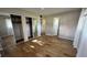 Main bedroom with wood-look tile floors and mirrored closet doors at 9612 Valencia Cv, Bradenton, FL 34210