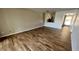 Spacious living area with wood-look tile floors and view of kitchen at 9612 Valencia Cv, Bradenton, FL 34210