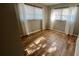 Bright bedroom featuring light wood-look floors and abundant natural light at 9612 Valencia Cv, Bradenton, FL 34210