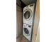 Stackable LG washer and dryer in a small laundry room at 9612 Valencia Cv, Bradenton, FL 34210
