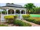 Charming gazebo surrounded by colorful landscaping and a putting green offers an idyllic spot for relaxation at 9612 Valencia Cv, Bradenton, FL 34210