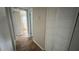 Hallway leading to bedroom, with wood-look tile flooring and closet at 9612 Valencia Cv, Bradenton, FL 34210