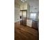 Modern kitchen featuring stainless steel appliances, granite countertops, and wood-look tile flooring at 9612 Valencia Cv, Bradenton, FL 34210