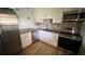 Kitchen featuring stainless steel appliances, white cabinets, and granite countertops at 9612 Valencia Cv, Bradenton, FL 34210