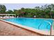 Refreshing community pool with surrounding lush greenery at 9612 Valencia Cv, Bradenton, FL 34210