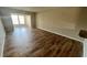 Bright living room featuring wood-look tile floors and views into adjacent dining area at 9612 Valencia Cv, Bradenton, FL 34210