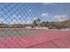 Community tennis courts with red surface and chain link fence at 9612 Valencia Cv, Bradenton, FL 34210