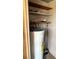 Utility closet with a water heater, shelving, and pegboard walls at 9612 Valencia Cv, Bradenton, FL 34210