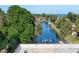 Scenic view of a peaceful waterway with lush greenery and docked boats at 9612 Valencia Cv, Bradenton, FL 34210
