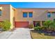 Tan colored condo building with red garage door at 4013 Catalina Dr # 4013, Bradenton, FL 34210