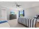 Guest bedroom with dresser, TV, and sliding glass doors to balcony at 4013 Catalina Dr # 4013, Bradenton, FL 34210