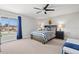 Comfortable bedroom with a striped bedspread, nightstands, and ceiling fan at 4013 Catalina Dr # 4013, Bradenton, FL 34210