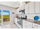 Bright kitchen with granite countertops, white cabinets, and stainless steel appliances at 4013 Catalina Dr # 4013, Bradenton, FL 34210