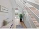 Bright entryway with bench, leading to an open living area and staircase at 4013 Catalina Dr # 4013, Bradenton, FL 34210