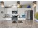 Modern kitchen with white cabinets, granite countertops and stainless steel appliances at 4013 Catalina Dr # 4013, Bradenton, FL 34210
