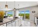 Modern kitchen with white cabinets, granite island and balcony access at 4013 Catalina Dr # 4013, Bradenton, FL 34210