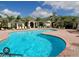 Community pool with curved design and surrounding patio at 5152 Northridge Rd # 302, Sarasota, FL 34238