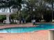 Resort-style pool with brick deck and shaded seating at 5152 Northridge Rd # 302, Sarasota, FL 34238