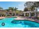 Community pool with pergola and lush landscaping at 5152 Northridge Rd # 302, Sarasota, FL 34238