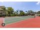 Well-maintained tennis court with surrounding trees at 5152 Northridge Rd # 302, Sarasota, FL 34238