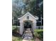 Building entrance with a covered walkway and well-maintained landscaping at 5152 Northridge Rd # 302, Sarasota, FL 34238