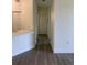 Clean hallway with light walls and wood-look floors at 5152 Northridge Rd # 302, Sarasota, FL 34238