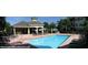 Community pool with adjacent covered patio and lounge chairs at 5152 Northridge Rd # 302, Sarasota, FL 34238
