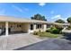 Front view of a single-story home with carport and well-maintained landscaping at 390 301 W Blvd # 5C, Bradenton, FL 34205