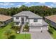 Two-story house with gray roof, landscaping, and a paved driveway at 16215 Tradewind Ter, Lakewood Ranch, FL 34211