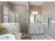 Modern bathroom with a walk-in shower, soaking tub, and white vanity at 16215 Tradewind Ter, Lakewood Ranch, FL 34211