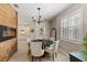 Elegant dining room with chandelier and built-in fireplace at 16215 Tradewind Ter, Lakewood Ranch, FL 34211