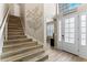 Modern staircase with wood-look tile and metal railing at 16215 Tradewind Ter, Lakewood Ranch, FL 34211