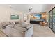 Relaxing living room with stone accent wall and large TV at 16215 Tradewind Ter, Lakewood Ranch, FL 34211