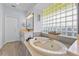 Spa-like bathroom with a soaking tub, double vanity, and separate shower at 7301 221St E St, Bradenton, FL 34211