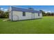 White and blue detached workshop with a ramp and hoop at 7301 221St E St, Bradenton, FL 34211