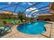 Relaxing pool with a covered patio, comfortable seating, and a waterfall feature at 7301 221St E St, Bradenton, FL 34211