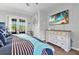 Bedroom with a king-size bed, dresser, and French doors leading to the backyard at 7301 221St E St, Bradenton, FL 34211
