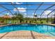 Relaxing kidney-shaped pool with a screened enclosure at 7301 221St E St, Bradenton, FL 34211
