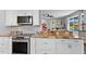 Modern kitchen with granite countertops, stainless steel appliances, and white cabinetry at 7301 221St E St, Bradenton, FL 34211