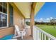 Spacious porch with white adirondack chairs overlooks a lush green landscape at 7301 221St E St, Bradenton, FL 34211