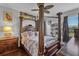 Bedroom with a large four-poster bed and wood floors at 7301 221St E St, Bradenton, FL 34211