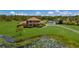 Aerial view of two story house on a large lot with pond at 7301 221St E St, Bradenton, FL 34211