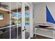 Glass doors reveal a refreshing pool area with lounge chairs and lush greenery at 7301 221St E St, Bradenton, FL 34211