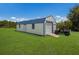 Detached workshop with large roll-up door and a nearby ATV at 7301 221St E St, Bradenton, FL 34211