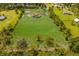 Aerial view of a house with a large lawn and pond at 7301 221St E St, Bradenton, FL 34211