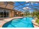 Stunning pool with screened enclosure, outdoor kitchen, and lounge area at 7301 221St E St, Bradenton, FL 34211