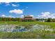 Two story house with pond in front and detached garage at 7301 221St E St, Bradenton, FL 34211