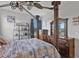 Bedroom with four-poster bed, dresser, and ceiling fan at 7301 221St E St, Bradenton, FL 34211